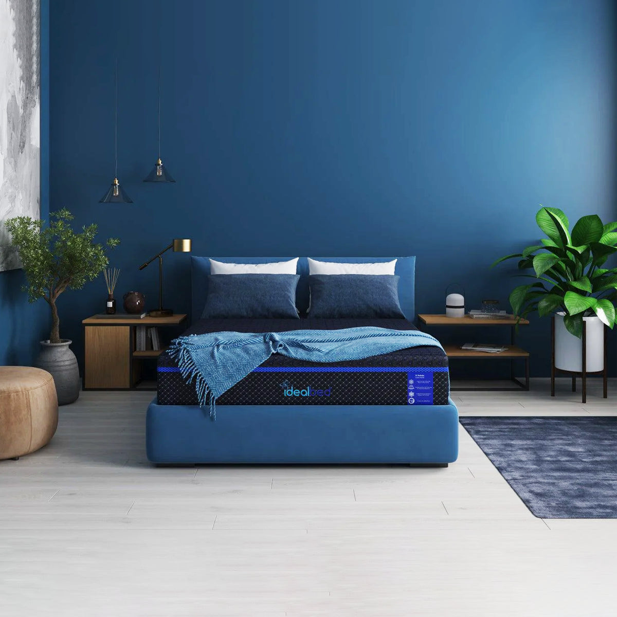 Front view of a G4 Nova Memory Foam Mattress styled in a deep blue bedroom setting with a plush medium soft feel.