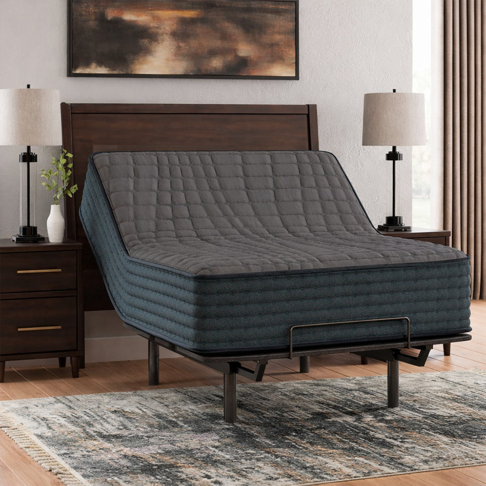 Gray 1200 Hybrid mattress by Ashley with the head section fully raised on a power base for reading or watching TV in a modern bedroom.
