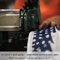 Skilled industrial sewing process of the navy blue polka-dot trim on a WinkBed, illustrating high-quality USA-made construction and durability.
