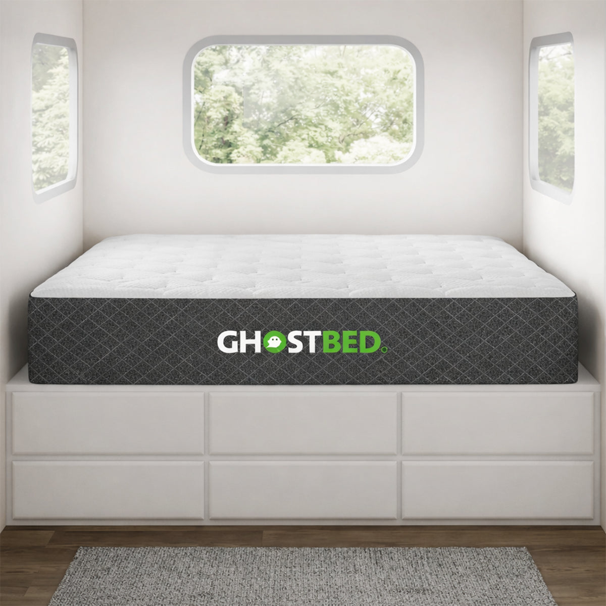 GhostBed RV 10-inch hybrid mattress fitted on a custom platform bed inside a modern camper van or tiny home.
