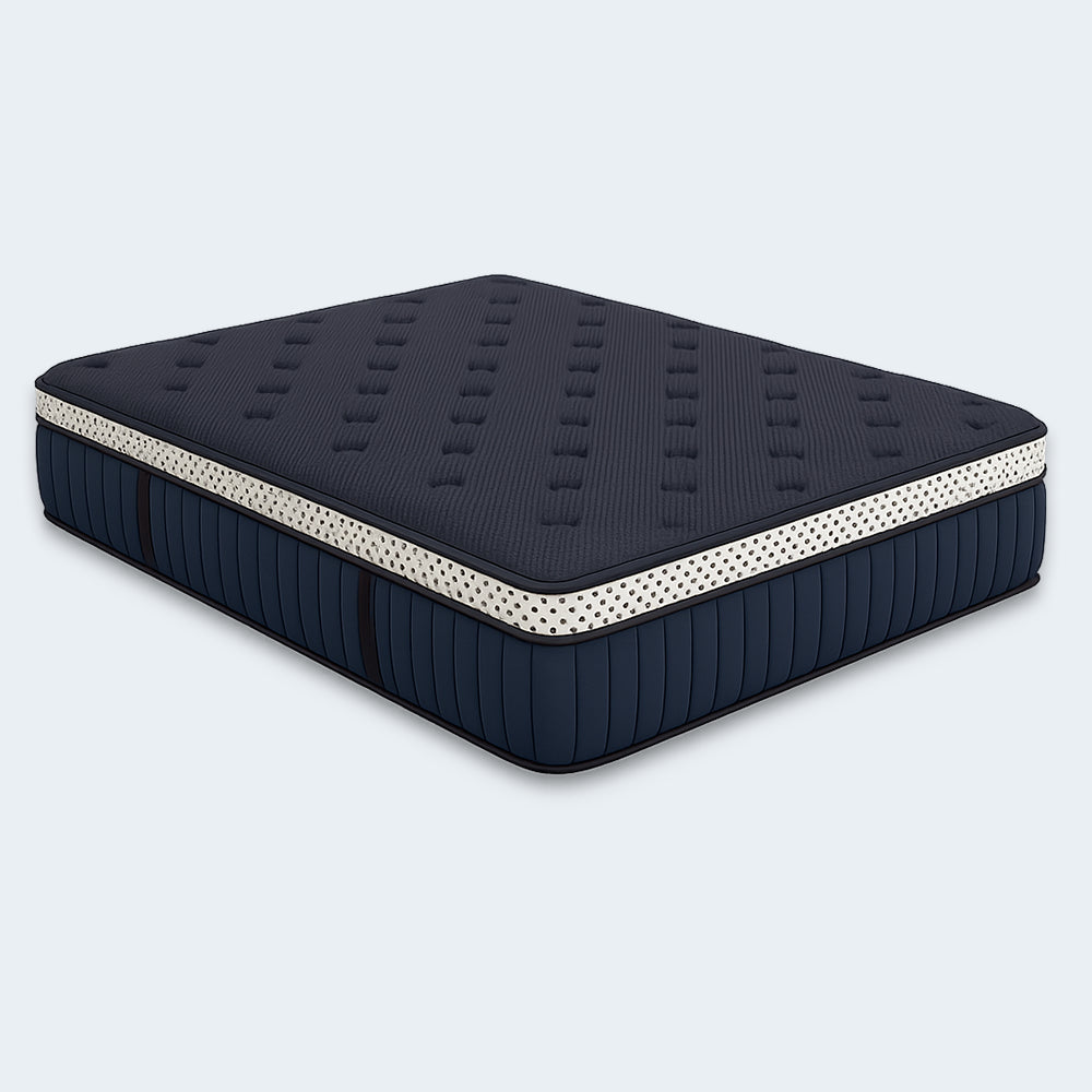 Three-quarter angled view of the navy blue WinkBeds Blue 15-inch luxury firm mattress featuring a tufted top and signature polka-dot border.
