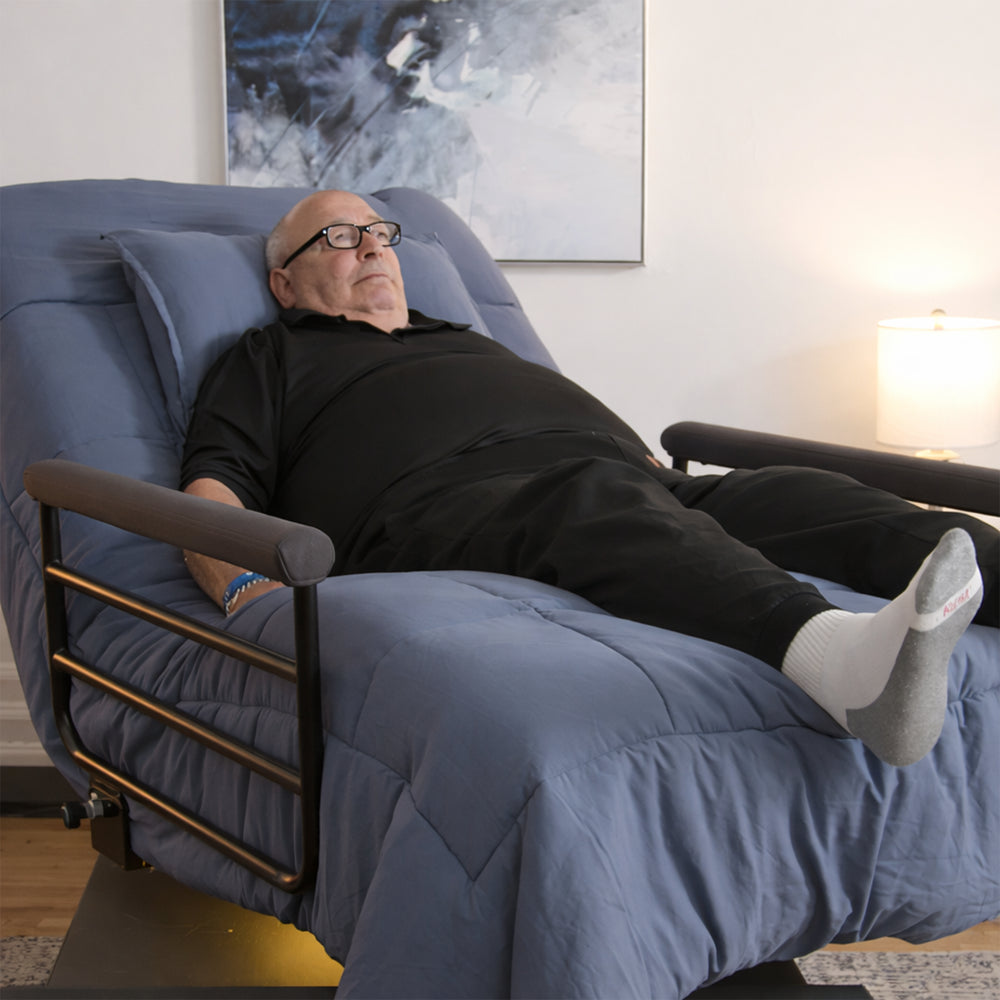 Senior man resting comfortably in the Independence motorized lift bed, demonstrating pressure relief and ergonomic support.
