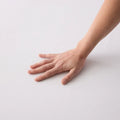 Soft-touch cooling fabric of the Malouf Omniphase mattress protector for a comfortable sleep surface.
