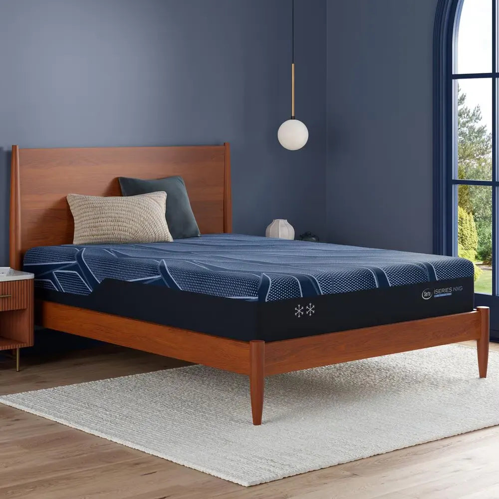 Serta iSeries NXG 1500 Hybrid Firm mattress in a styled bedroom for supportive, pressure-relieving sleep.

