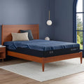 Serta iSeries NXG 1500 Hybrid Firm mattress in a styled bedroom for supportive, pressure-relieving sleep.
