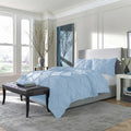 Soft light blue SleepTone Tranquility pinch pleat bedding set providing a serene and breathable sleep.
