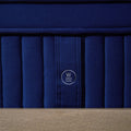 Detailed view of the Weekender 'W' emblem on the vertical channel-quilted side of the 11-inch luxury hybrid mattress.
