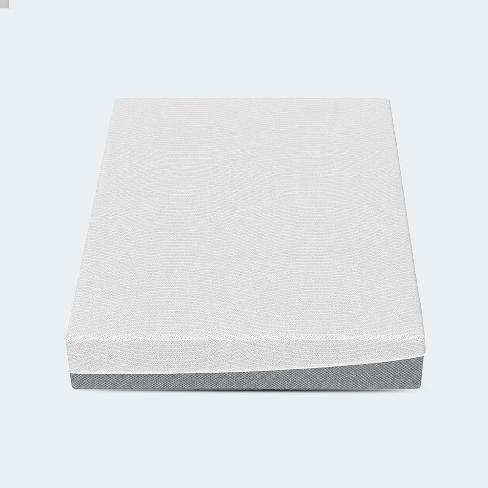 Top-down studio perspective of the EcoCore Hybrid Deluxe mattress showing the geometric patterned white cover.
