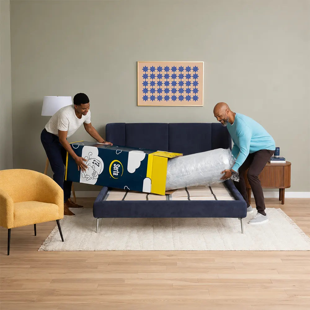 Two men easily unboxing the Serta Perfect Day 8 inch Medium Mattress from its compact shipping box.

