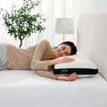 Smiling woman sleeping on a Sleeptone adjustable cooling choice gel pillow for comfortable neck support.
