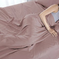 Comfortable mauve Hyper-Cotton sheets designed for air circulation and quick-dry cooling.
