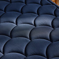 Detailed close-up of the DreamCloud Ultra signature navy blue scalloped quilted cover designed for maximum breathability and plush comfort.
