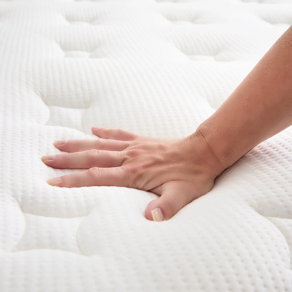 Detailed close-up of the Weekender 13-inch mattress corner featuring white quilted fabric and reinforced navy blue vertical stitching.
