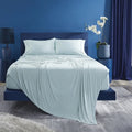 Light blue BEDGEAR Ver-Tex cooling sheets draped over a bed for a calm, temperature-neutral sleep.

