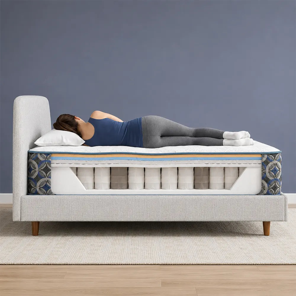 Side sleeper demonstrating proper spinal alignment on a cutaway of the Serta Cascade Bluff Hybrid mattress.
