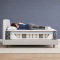 Side sleeper demonstrating proper spinal alignment on a cutaway of the Serta Cascade Bluff Hybrid mattress.

