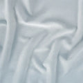 Macro texture of light blue Hyper-Wool performance fabric for optimal airflow and infant comfort.
