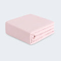 Folded pink BEDGEAR Hyper-Wool performance crib sheet for a dry and comfortable baby sleep environment.
