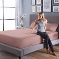 Durable mauve Hyper-Cotton fitted sheet with Powerband for a secure, non-slip bed fit.
