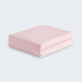 Folded pink BEDGEAR Hyper-Linen performance crib sheet, moisture-wicking for a comfortable nursery.

