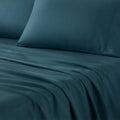Close-up of teal Hyper-Cotton pillowcases on breathable sheets for a refreshing sleep.
