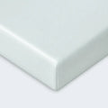 Secure corner of a mint green Dri-Tec fitted crib sheet for a smooth, safe sleep surface.
