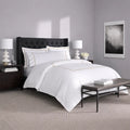 SleepTone Hotel Luxury 6-piece white sheet set with grey embroidery in a curated master bedroom.
