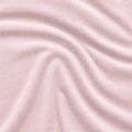 Macro texture of pink Hyper-Wool performance fabric showing the breathable, soft moisture-wicking knit.
