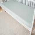  Sage green Hyper-Wool performance crib sheet on a white crib for a cool and dry nursery setting.
