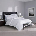 SleepTone Hotel Luxury 6-piece white sheet set with grey embroidery in a curated master bedroom.
