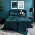 Lifestyle view of teal BEDGEAR Hyper-Cotton sheets in a modern, color-coordinated bedroom.
