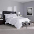 SleepTone Hotel Luxury 6-piece white sheet set with grey embroidery in a curated master bedroom.
