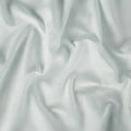 Folded sage green Hyper-Linen performance crib sheet by BEDGEAR for a breathable and dry sleep surface.
