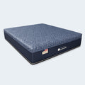 Angled view of the Americanstar Wave 13.5-inch firm mattress showcasing its navy blue side panels and modern geometric quilted cover design.
