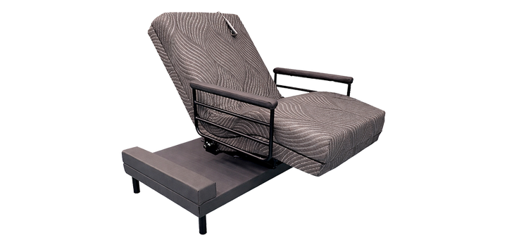 Customatic The Independence Adjustable Journey Upbed motorized lift bed shown in its 90-degree rotated sit-to-stand seated position with safety rails.
